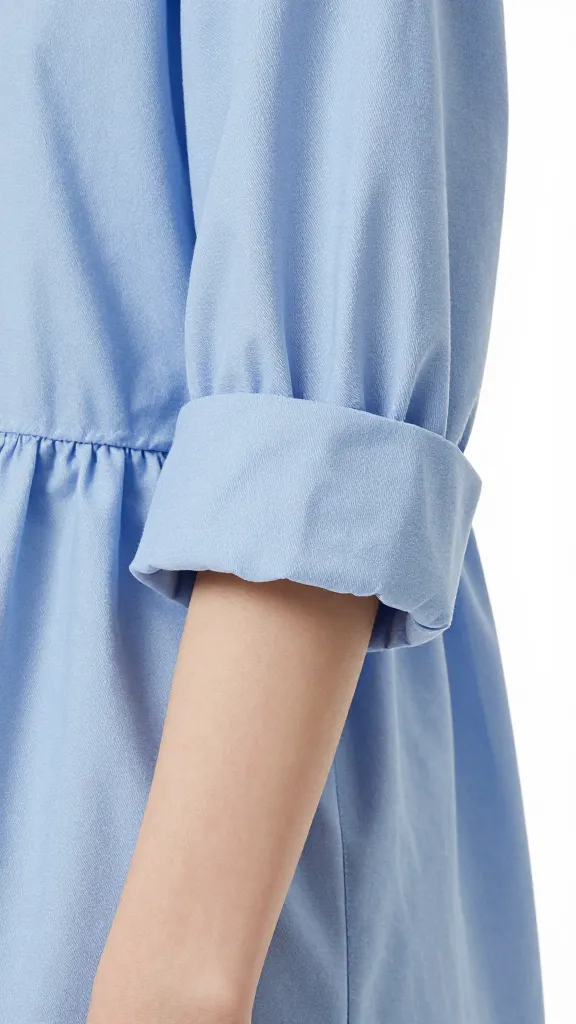closeup of rolled sleeves on blue cotton poplin shirtdress