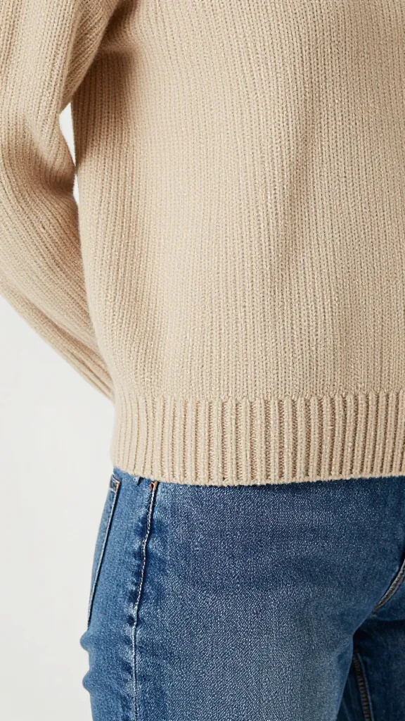 ribbed oatmeal knit sweater, closeup French-tucked hem detail in jeans