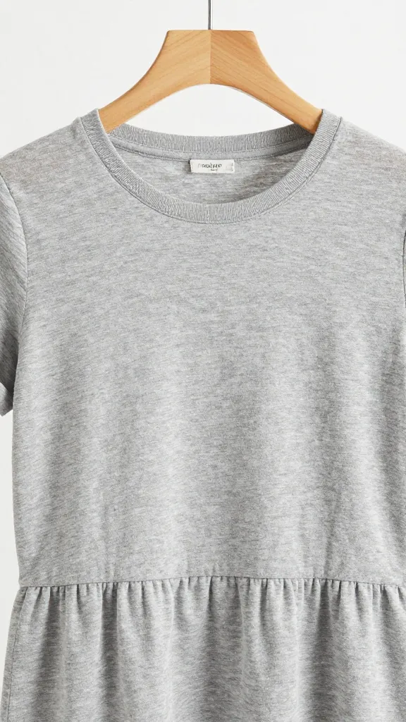heather-grey cotton T-shirt dress on wooden hanger, closeup